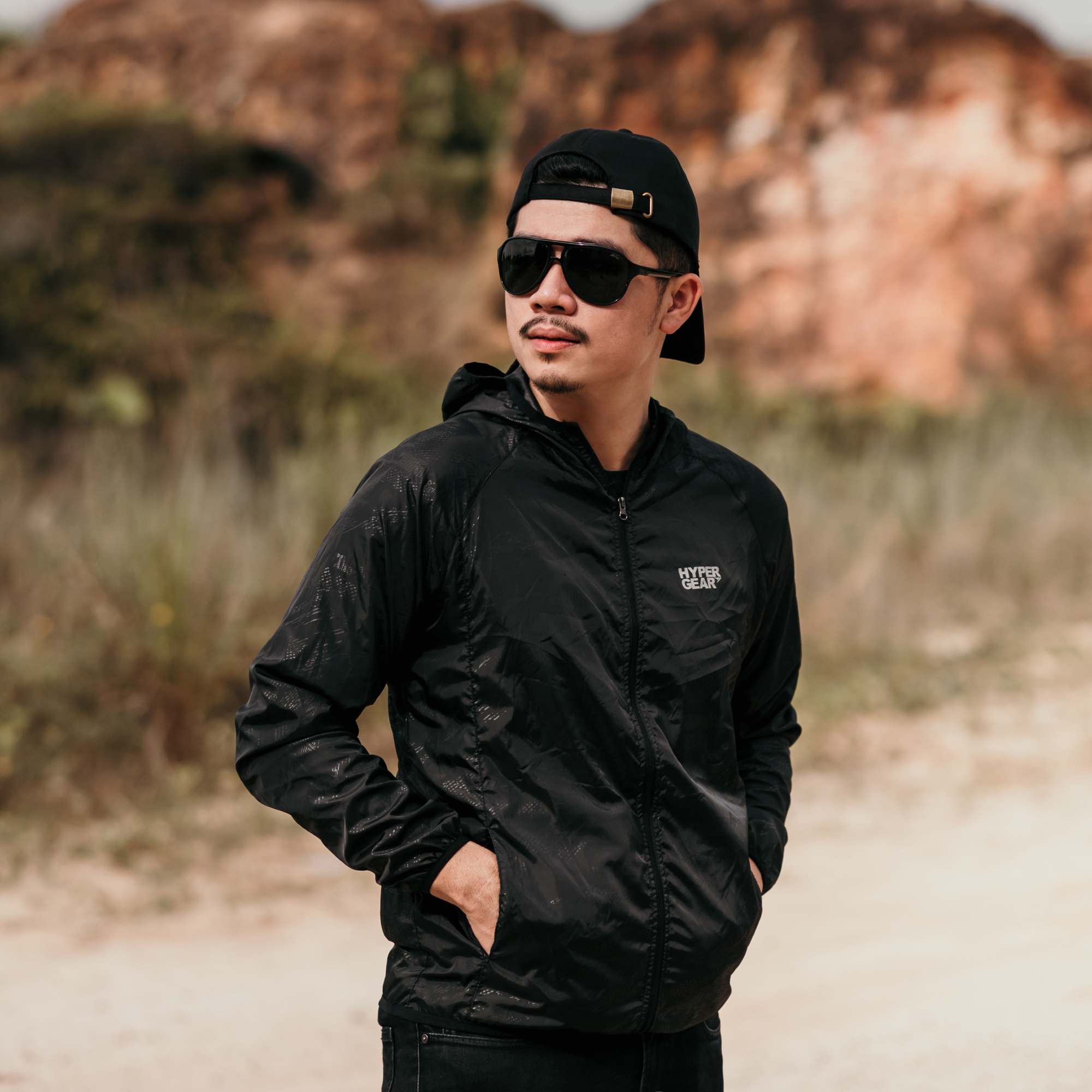 A person wearing the lightweight Hypergear Windbreaker outdoor, showcasing its use as a performance outer layer.